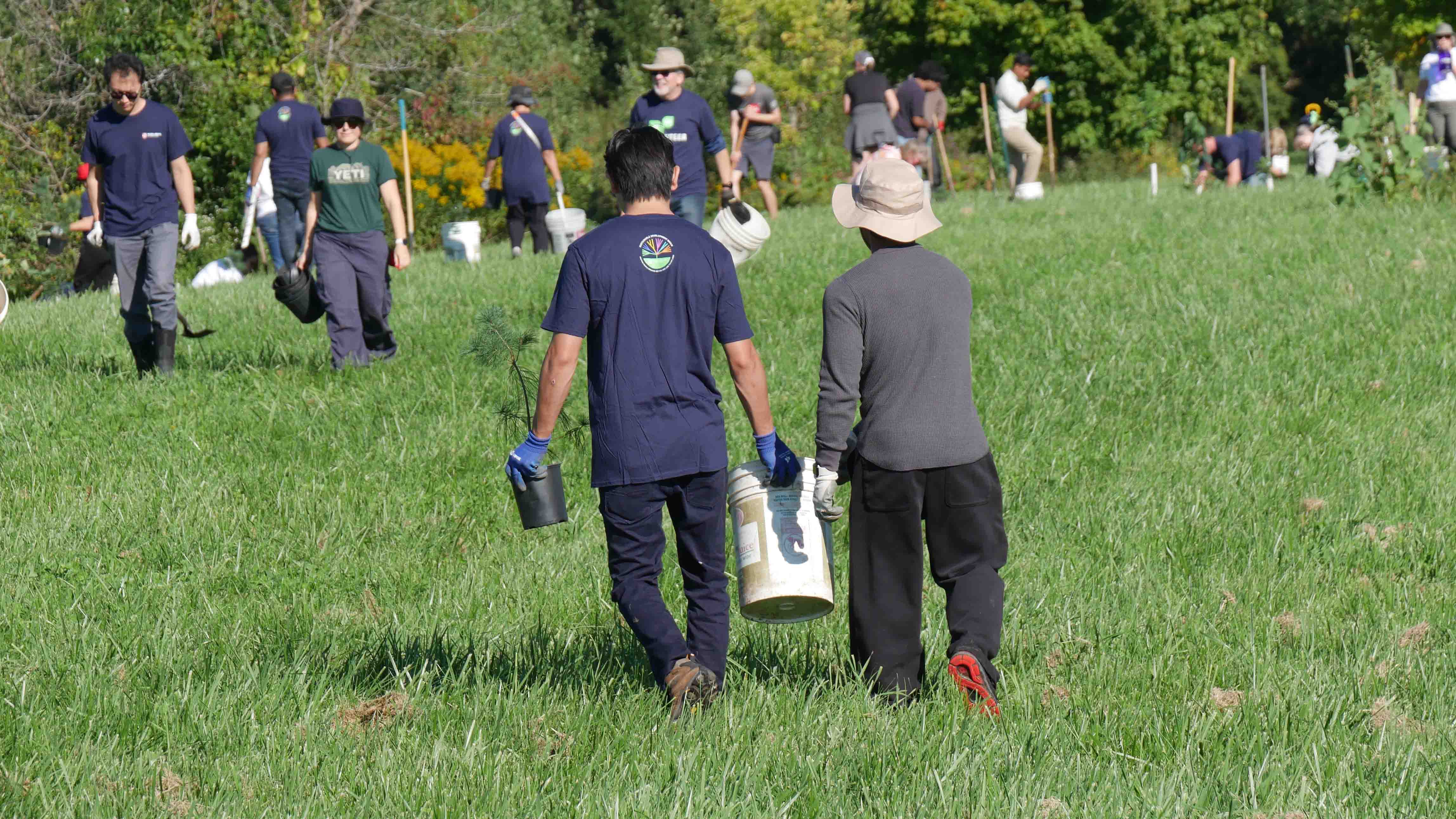 People walking with buckets in hand